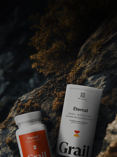 Grail Eternal NAD+ Booster supplement bottles on a dark, textured surface